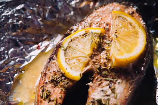fish steak baked with lemon and herbs in foil
