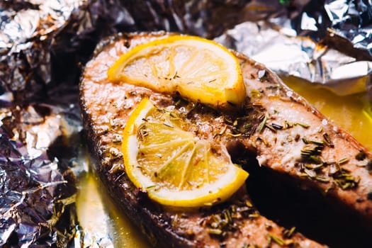 fish steak baked with lemon and herbs in foil