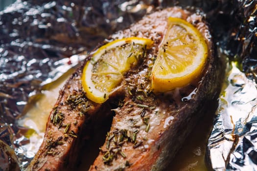 fish steak baked with lemon and herbs in foil