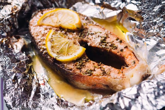 fish steak baked with lemon and herbs in foil