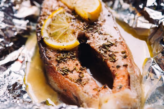 fish steak baked with lemon and herbs in foil