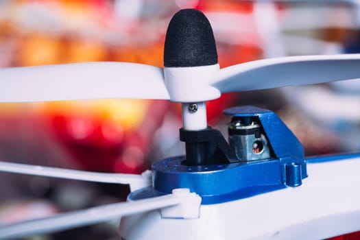 quadrocopters engine and propeller close to the blurred background