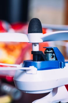 quadrocopters engine and propeller close to the blurred background