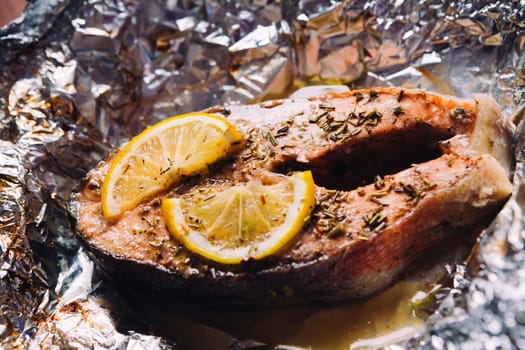 fish steak baked with lemon and herbs in foil