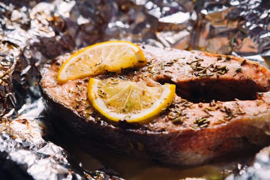 fish steak baked with lemon and herbs in foil
