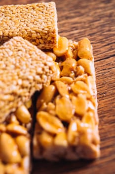 Kozinaki of sesame and peanut on a wooden background