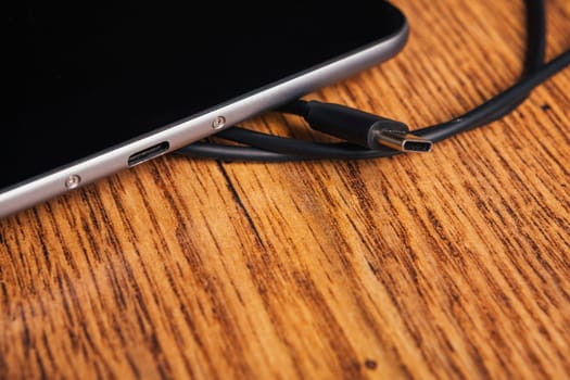 new tablet with built-in usb-c on wooden background
