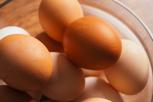 fresh rural eggs in a clear bowl