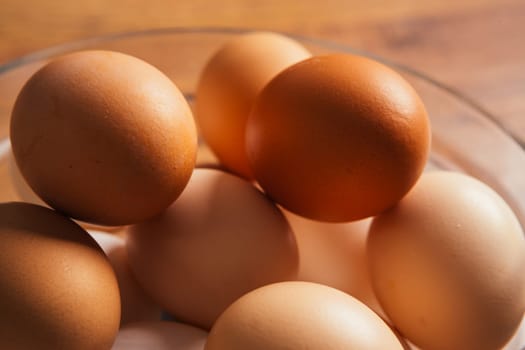 fresh rural eggs in a clear bowl