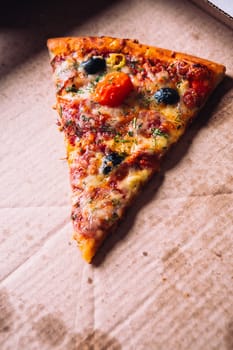 pieces of pizza with olives, cheese and salami sausage