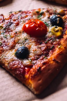 pieces of pizza with olives, cheese and salami sausage