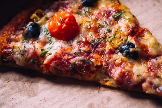 pieces of pizza with olives, cheese and salami sausage