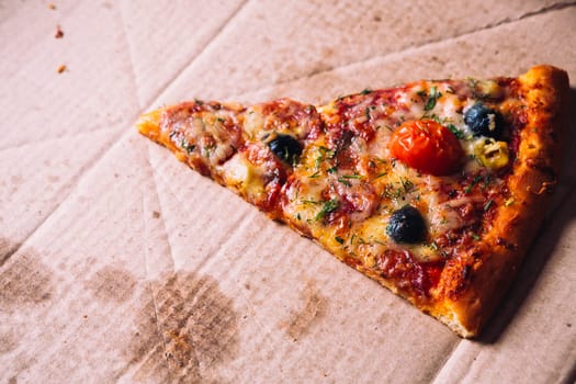 pieces of pizza with olives, cheese and salami sausage