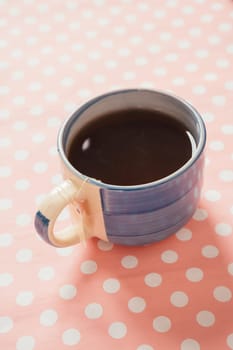 blue cup of tea on pink background