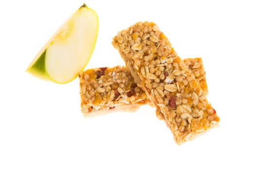 muesli bars with dried fruit on isolated background with apple