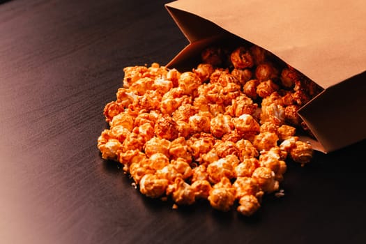 many popcorn in a paper bag on a dark background