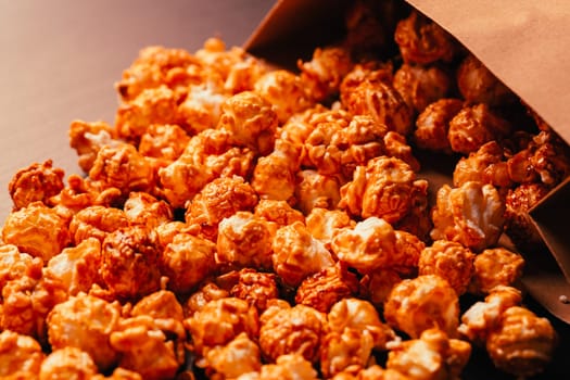 many popcorn in a paper bag on a dark background