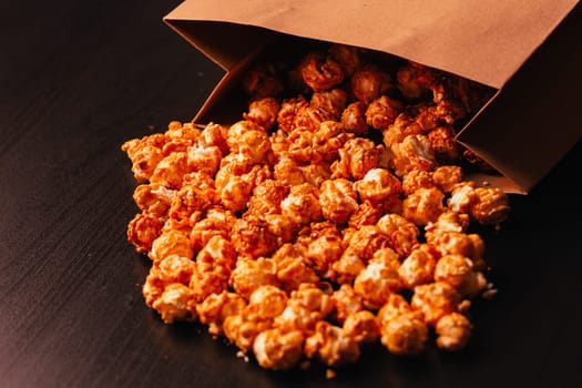 many popcorn in a paper bag on a dark background
