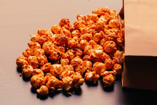 many popcorn in a paper bag on a dark background