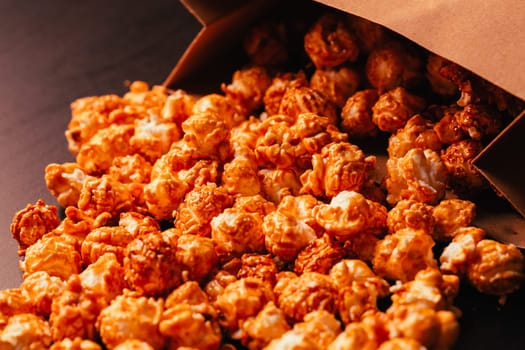 many popcorn in a paper bag on a dark background