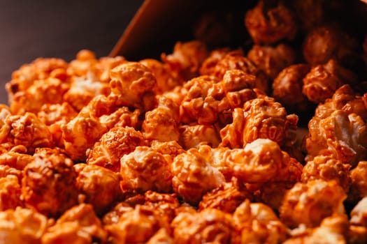 many popcorn in a paper bag on a dark background