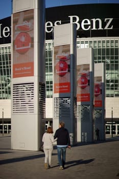 Berlin, Germany - November 06, 2018: Pedestrians pass by advertising columns at the Mercedes-Benz-Arena on November 6, 2018 in Berlin..