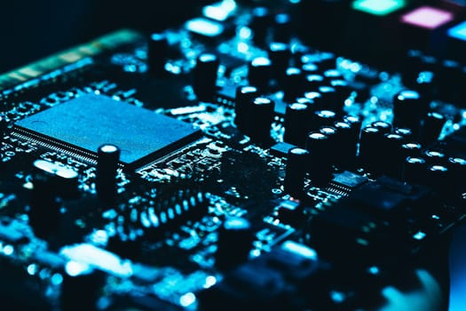 computer motherboard in blue dark background close-up.