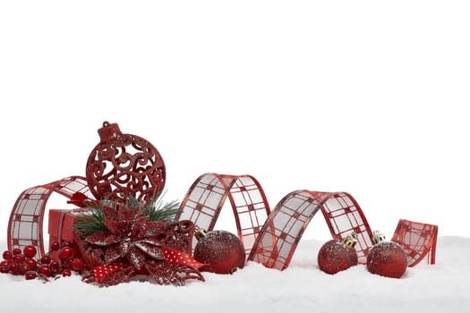 Christmas still life with red gift box and Christmas decorations lying on winter snow on a white background with copy space. New Year and Christmas. Greeting card