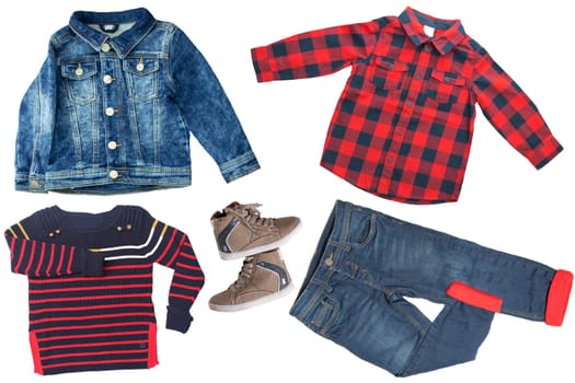 Top view on child boy set of clothes. Collage of apparel clothing. Jeans ,shirt, shoes and jeans jacket isolated on a white background. Jeans and t-shirt fashion.