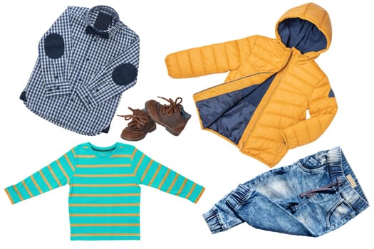 Top view on child boy set of clothes. Collage of apparel clothing. Jeans , shirt, shoes and warm down jacket isolated on a white background. Autumn and winter fashion.