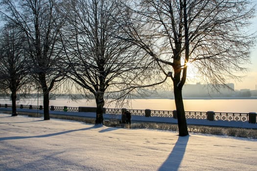 View of Riga from the 11th November Embankment side. Riga view in winter. Frozen river Daugava at the 11th November Embankment.