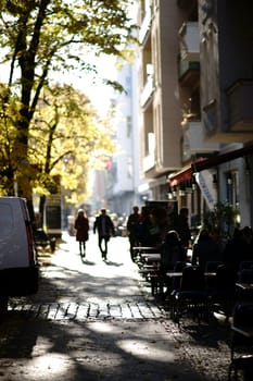 Berlin, Germany - November 06, 2018: Pedestrians walking and passing shops and cafes in Berlin's trendy district Friedrichshain on  November 06, 2018 in Berlin..