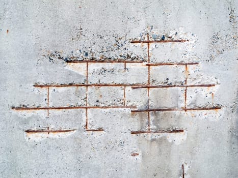 Full-size view on a damaged concrete wall with translucent iron.