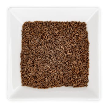 Caraway seeds in a bowl isolated on white background