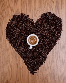 heart of coffee beans with espresso cup