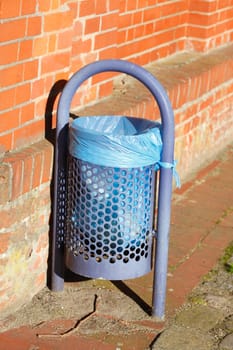 Garbage Can with blue plastic bag