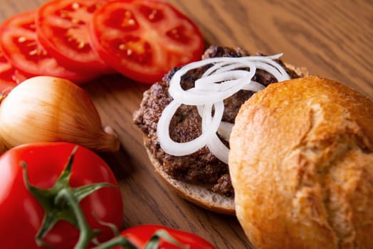 home made hamburger with meat, onion and tomato