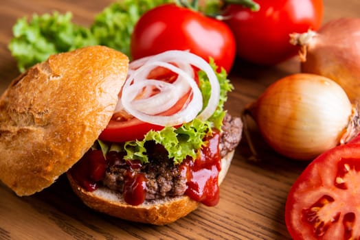 home made hamburger with meat, onion and tomato