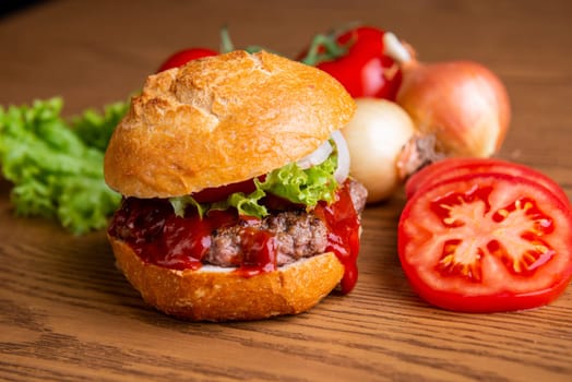 home made hamburger with meat, onion and tomato