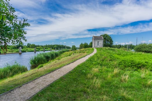 small shed with walking path at the lake distance view
