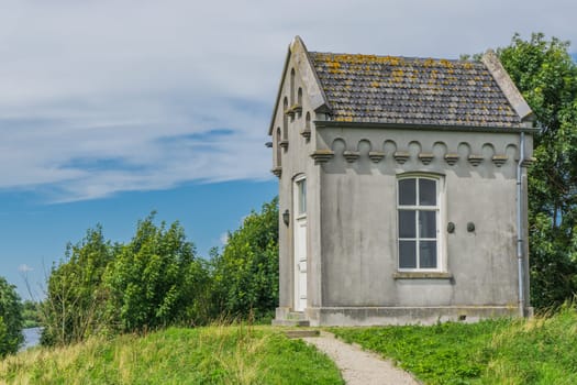 small cottage looking like a crypt in nature landscape