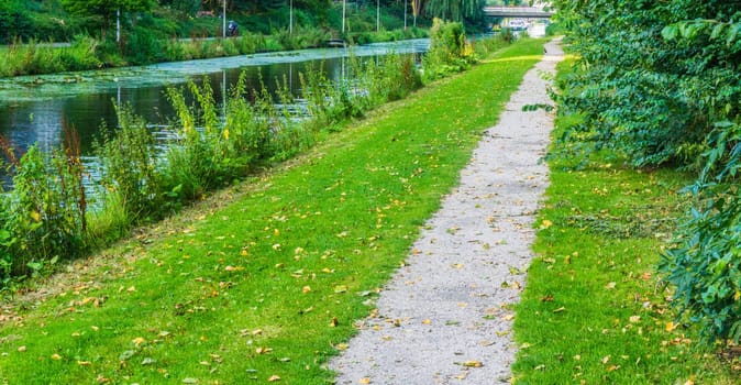 long straight walking road next to the lake water landscape