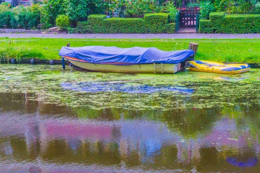 covered up boat with canvas in a river landscape