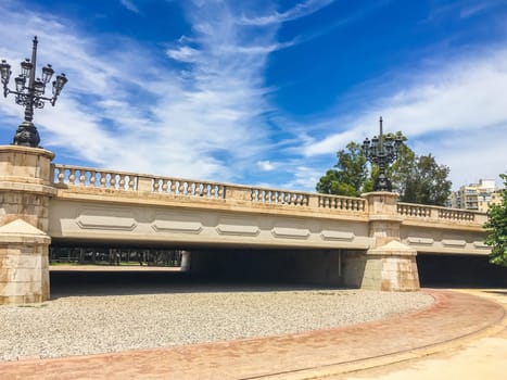beautiful stone bridge in turia park Spain with road