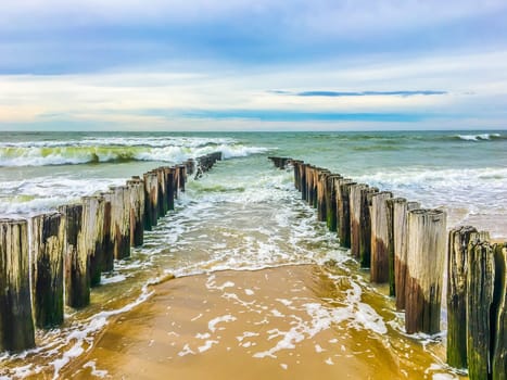 Ocean coast line with poles on a beach sea landscape photography