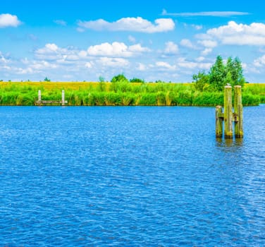 blue water river landscape with poles