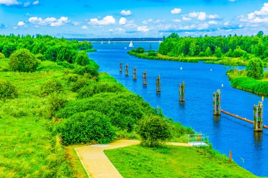 beautiful river landscape with footpath poles and boats sky view