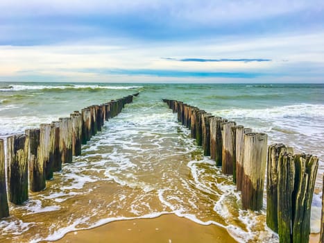 Beautiful beach landscape with ocean coastline and poles
