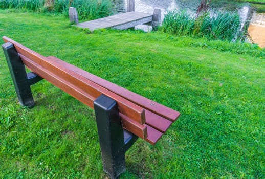 wooden bench at the park lake