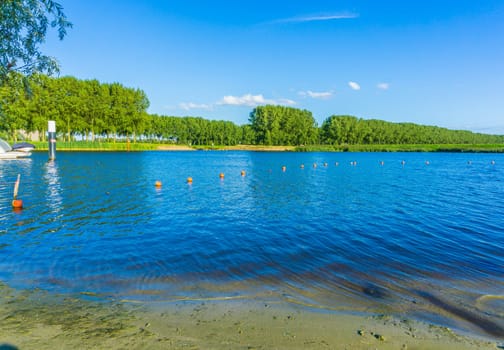Lake view in a water landscape with beach and forest view